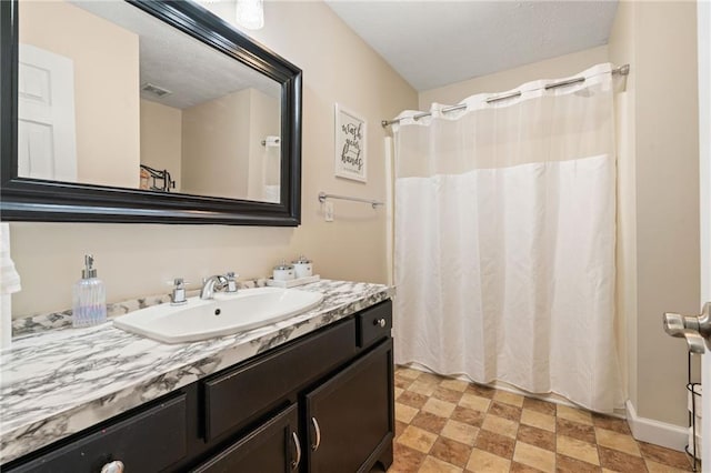 full bath with a shower with curtain, visible vents, vanity, and tile patterned floors