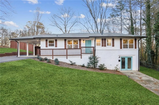 view of front of house with french doors, a carport, and a front lawn