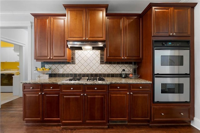 32 Pullman Trl, Acworth, GA 30101 - kitchen with white double oven, range hood, stainless steel gas cooktop, light stone countertops, and ornamental molding
