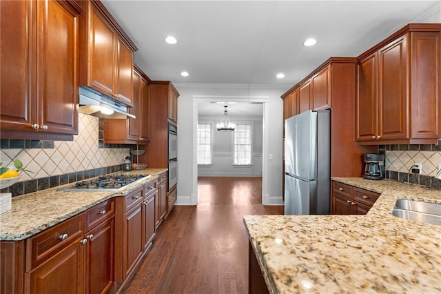 32 Pullman Trl, Acworth, GA 30101 - kitchen featuring stainless steel appliances, under cabinet range hood, a chandelier, light stone counters, and crown molding