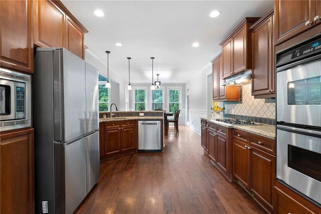 32 Pullman Trl, Acworth, GA 30101 - kitchen with stainless steel appliances, a peninsula, dark wood-style flooring, backsplash, and pendant lighting