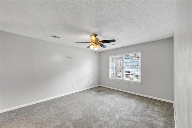 carpeted spare room with a textured ceiling and ceiling fan