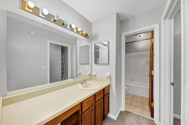 full bathroom with vanity, tiled shower / bath, tile patterned flooring, toilet, and a textured ceiling