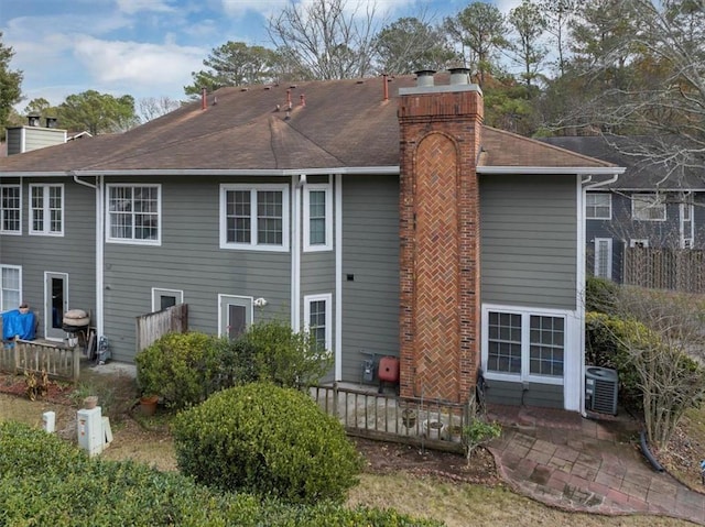 rear view of house featuring cooling unit