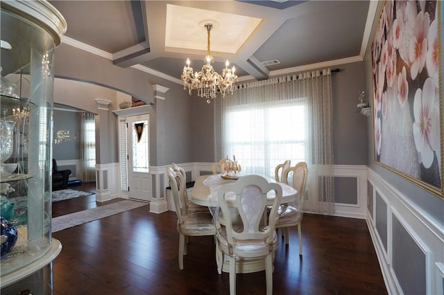 dining space with ornamental molding, coffered ceiling, a notable chandelier, and dark hardwood / wood-style flooring