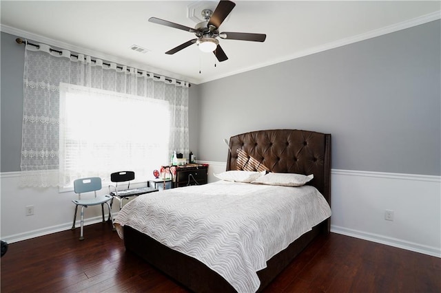 bedroom with ornamental molding, dark wood-type flooring, and ceiling fan