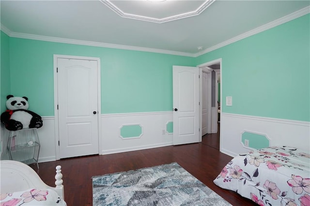 bedroom with ornamental molding and dark hardwood / wood-style flooring