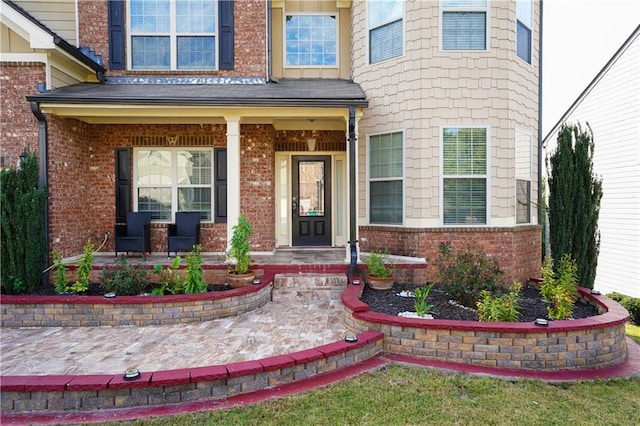 view of exterior entry featuring a porch