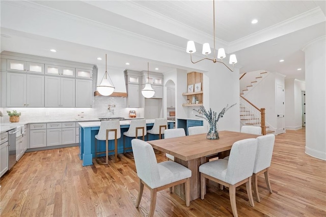 dining room with ornamental molding, light wood-style floors, stairway, recessed lighting, and a chandelier