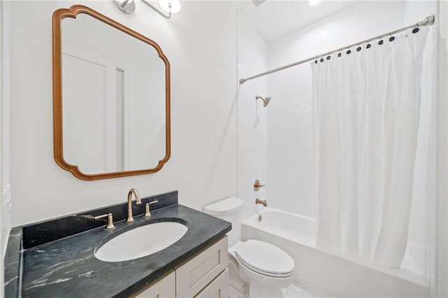 bathroom with toilet, shower / tub combo, and vanity