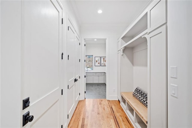 mudroom with light wood-style floors, recessed lighting, and baseboards