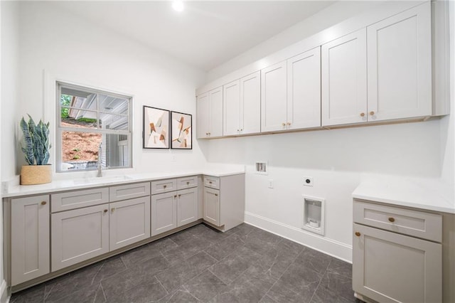 laundry room featuring cabinet space, electric dryer hookup, hookup for a washing machine, and baseboards