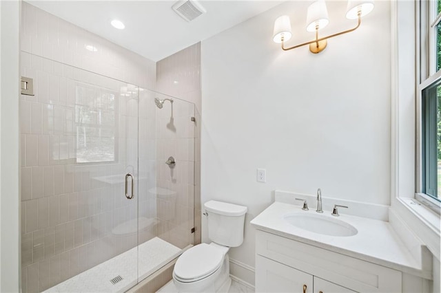 full bathroom with toilet, a shower stall, vanity, and baseboards