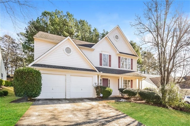 view of property with a front yard and a garage