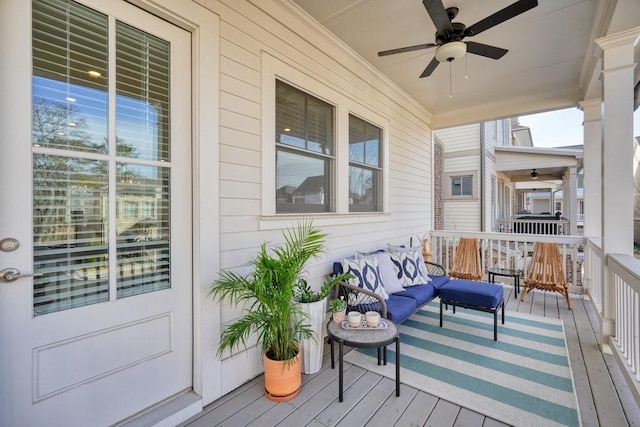 deck with a ceiling fan and outdoor lounge area