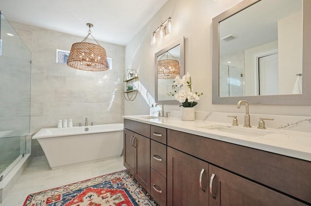 full bathroom featuring a stall shower, a soaking tub, double vanity, and marble finish floors