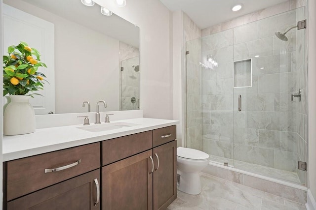 full bathroom featuring a stall shower, toilet, vanity, and recessed lighting