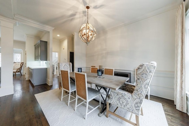 dining room with a notable chandelier, ornamental molding, dark wood-style flooring, and recessed lighting