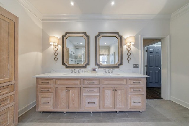 bathroom with ornamental molding, a sink, baseboards, and double vanity