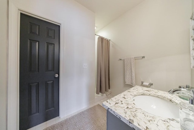 bathroom featuring a shower with shower curtain, vanity, and tile patterned floors