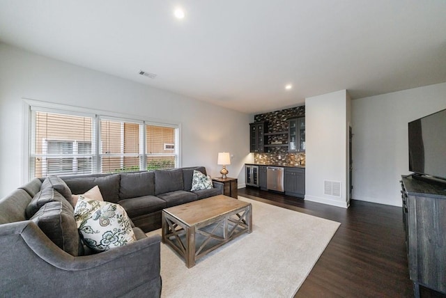 living area with dark wood-style floors, a dry bar, visible vents, and recessed lighting