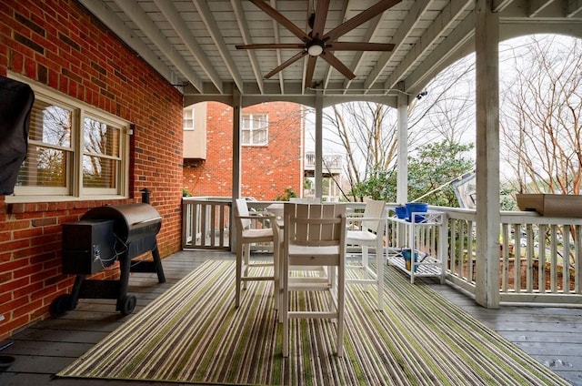 wooden terrace with ceiling fan, outdoor dining space, and grilling area