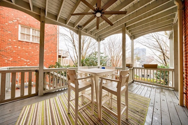 wooden terrace featuring a ceiling fan and outdoor dining area