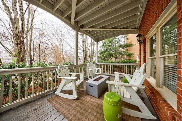 wooden terrace with an outdoor fire pit