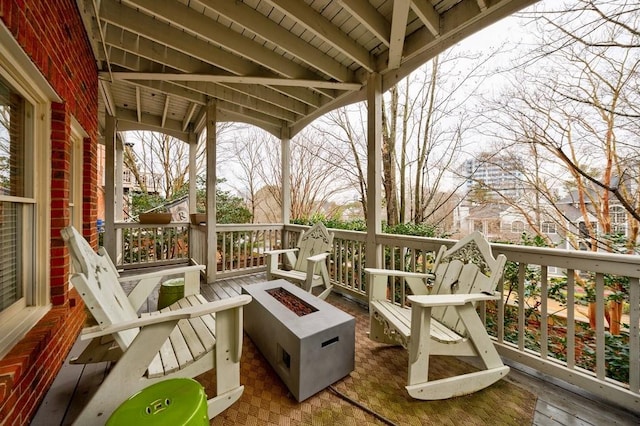 wooden deck featuring an outdoor fire pit