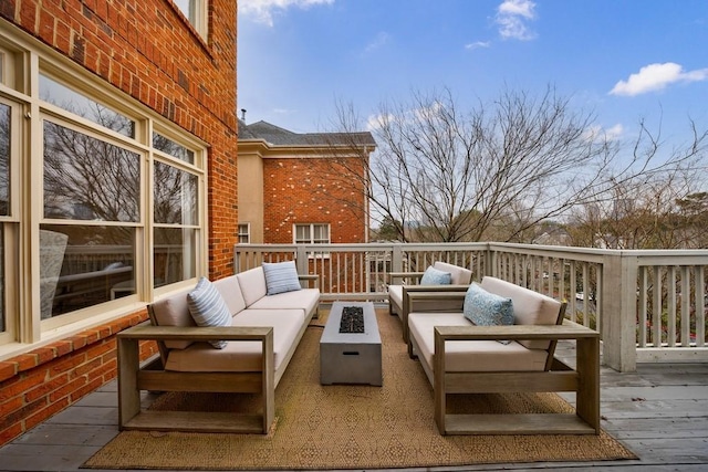 wooden deck with an outdoor living space