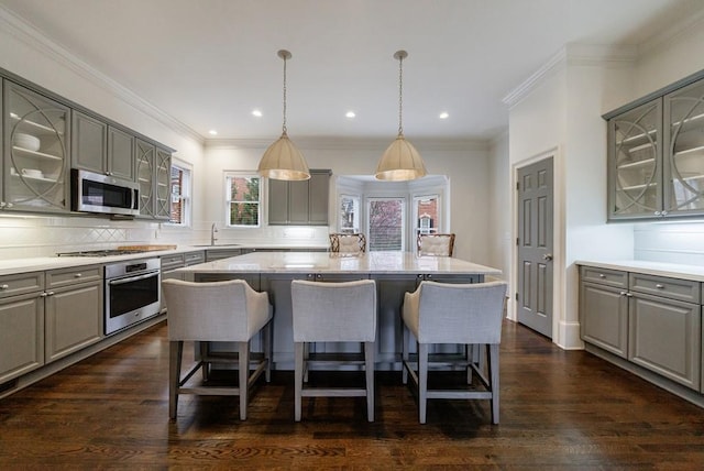 kitchen with stainless steel appliances, a center island, and gray cabinets