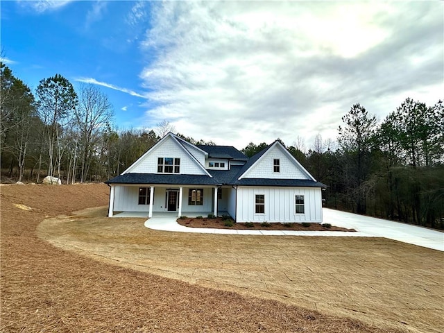 modern farmhouse with covered porch and board and batten siding