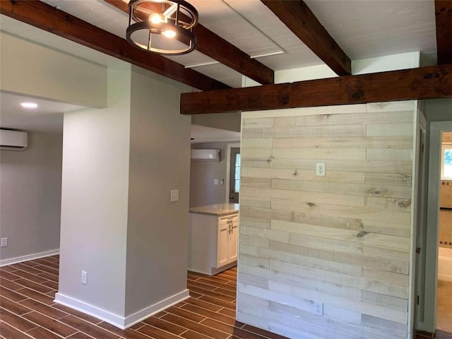 interior space with an AC wall unit, dark hardwood / wood-style floors, and beam ceiling