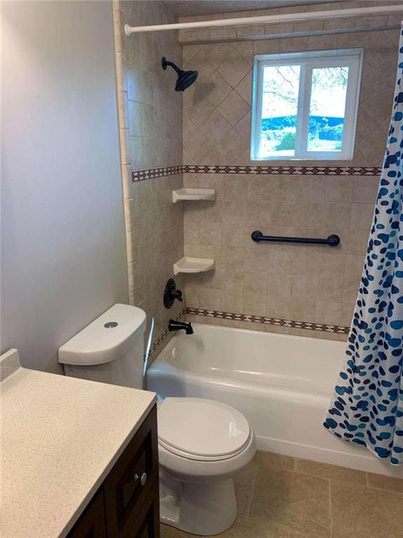 full bathroom featuring tile patterned flooring, vanity, toilet, and shower / tub combo