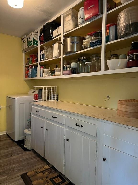 1017 Clifton Dr, Macon, GA 31204 - laundry area featuring dark wood-style floors, cabinet space, and washer / dryer