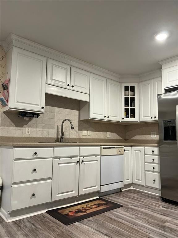 1017 Clifton Dr, Macon, GA 31204 - kitchen featuring stainless steel refrigerator with ice dispenser, white dishwasher, white cabinets, dark wood finished floors, and tasteful backsplash