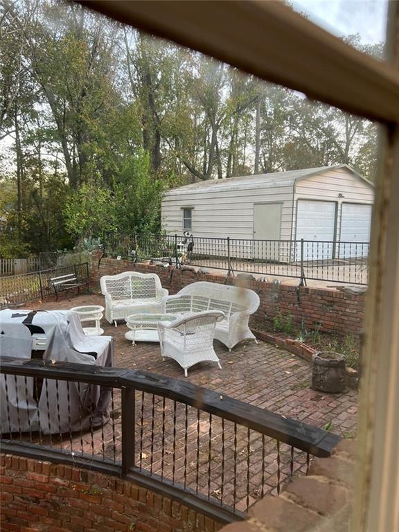 1017 Clifton Dr, Macon, GA 31204 - view of patio / terrace featuring a detached garage and an outdoor structure
