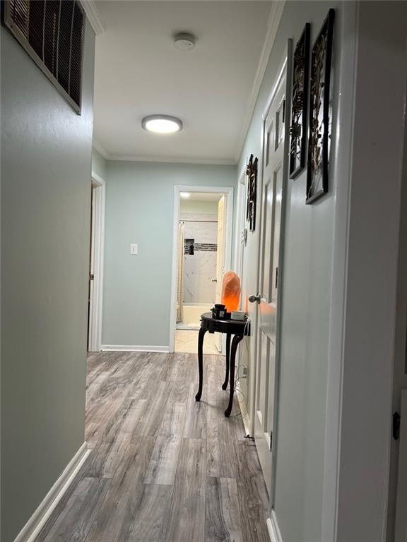 1017 Clifton Dr, Macon, GA 31204 - corridor featuring crown molding, wood finished floors, and baseboards