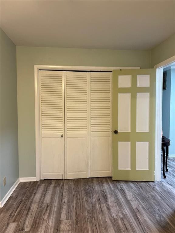 1017 Clifton Dr, Macon, GA 31204 - unfurnished bedroom featuring dark wood-style floors, a closet, and baseboards