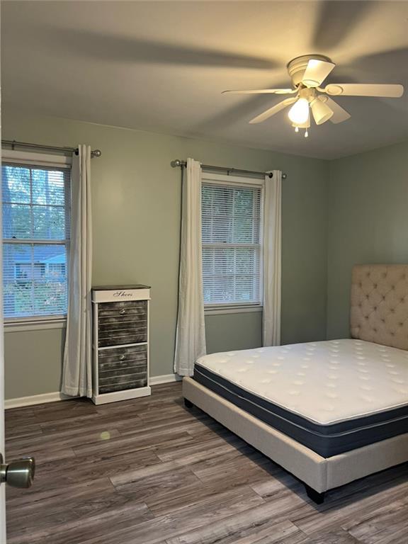 1017 Clifton Dr, Macon, GA 31204 - bedroom with dark wood-type flooring, ceiling fan, and baseboards