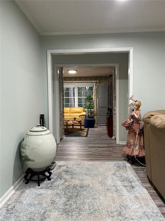 1017 Clifton Dr, Macon, GA 31204 - hallway featuring ornamental molding, wood finished floors, and baseboards