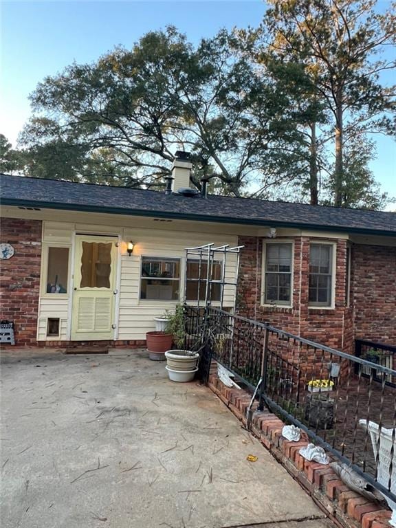 1017 Clifton Dr, Macon, GA 31204 - view of front of property featuring a patio area, a chimney, and brick siding