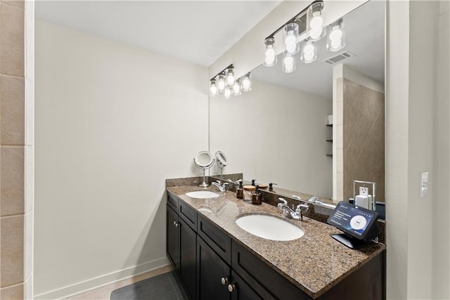 1382 Stirling Cir NW, Atlanta, GA 30318 - bathroom with double vanity, a sink, baseboards, and visible vents