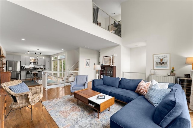 1382 Stirling Cir NW, Atlanta, GA 30318 - living room with recessed lighting, wood finished floors, and stairway