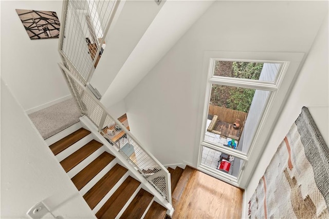 1382 Stirling Cir NW, Atlanta, GA 30318 - staircase with baseboards, lofted ceiling, and wood finished floors