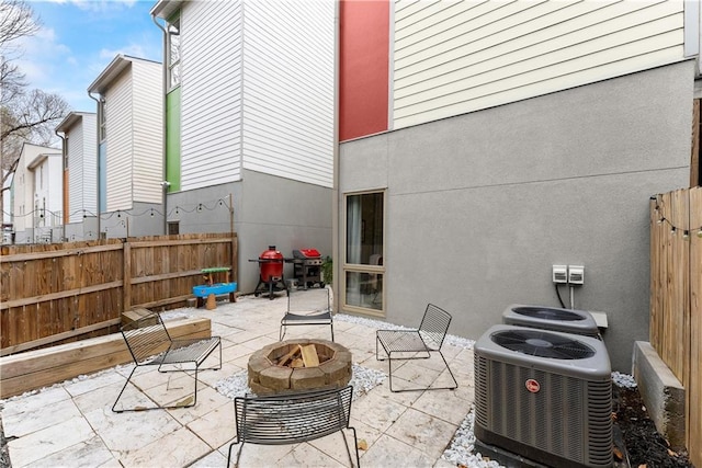 1382 Stirling Cir NW, Atlanta, GA 30318 - view of patio / terrace with an outdoor fire pit, central AC, and fence