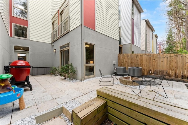 1382 Stirling Cir NW, Atlanta, GA 30318 - view of patio featuring cooling unit, a fire pit, and fence
