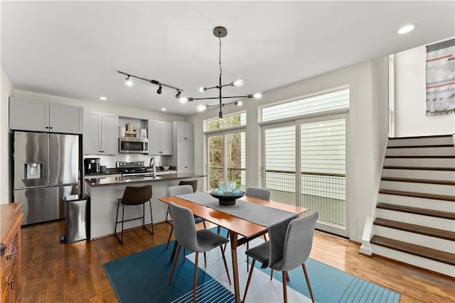 1382 Stirling Cir NW, Atlanta, GA 30318 - dining room featuring dark wood-style flooring, a notable chandelier, and stairway