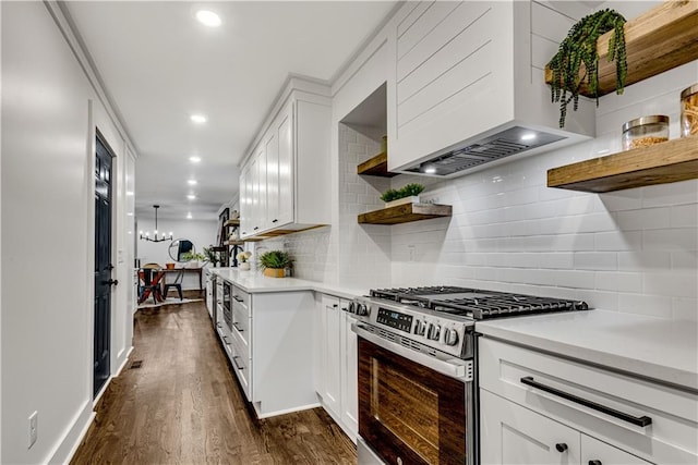 kitchen with white cabinets, dark hardwood / wood-style floors, stainless steel range with gas cooktop, and premium range hood