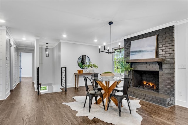 dining area featuring ornamental molding, a brick fireplace, and dark hardwood / wood-style floors